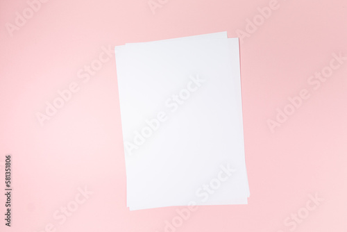 empty white paper sheet on pink background. Mockup © TropicalNinjaStudio