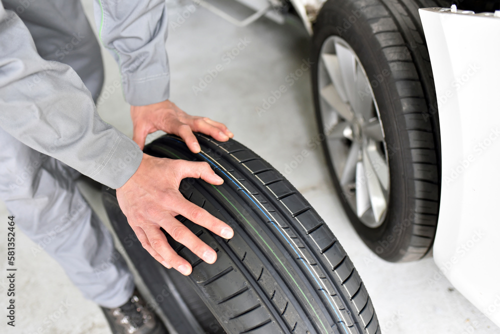 tyre change in a car repair shop worker assembles rims on the vehicle
