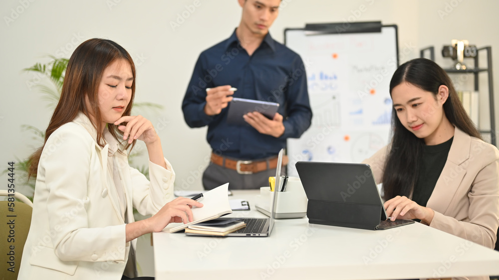 Business team brainstorming, discussing over new marketing at corporate meeting Business team brainstorming, discussing over new marketing at corporate meeting