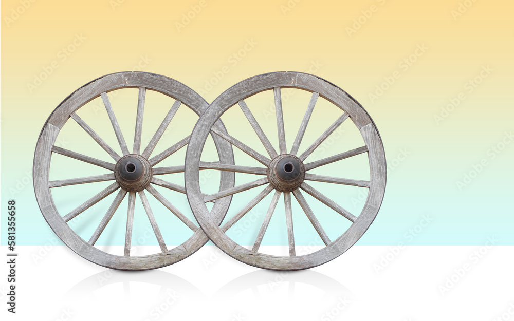two wooden and rust steel wagon wheel on gradient yellow and blue background, object, vintage, transport, decor, copy space