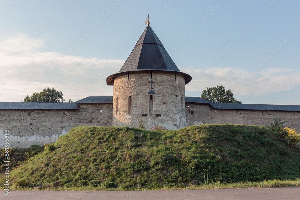 View of the wall and towers of The Holy Dormition Pskovo-Pechersky Monastery. Russia.