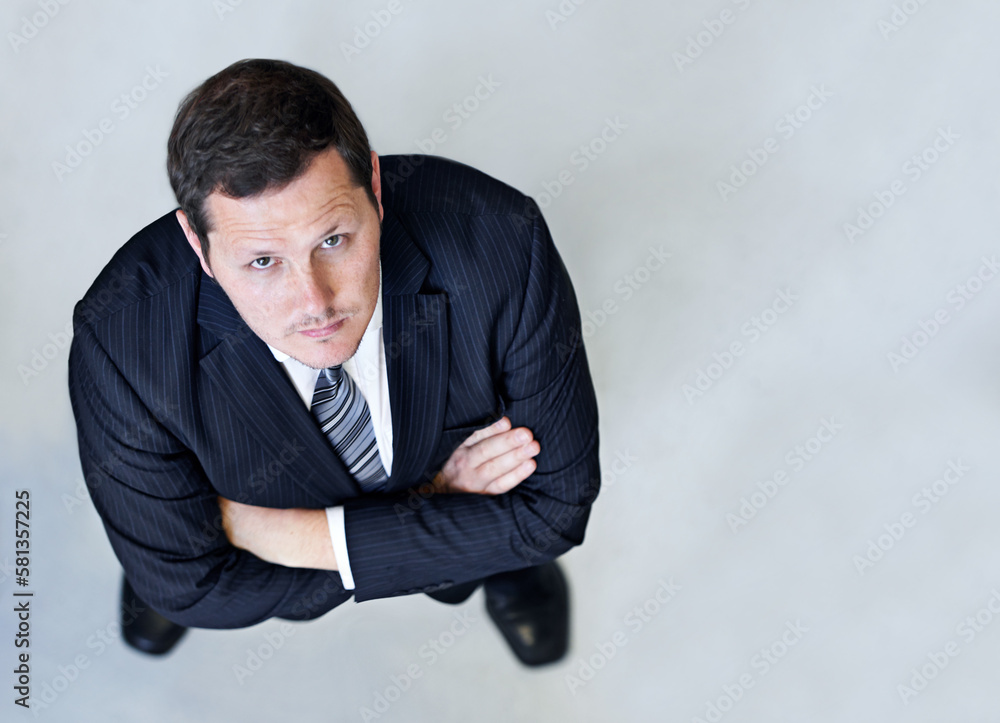 Confidence in the workplace. High angle portrait of a confident looking businessman. Confidence in the workplace. High angle portrait of a confident looking businessman.