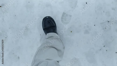 Young man walks through snowdrifts in winter. POV video.