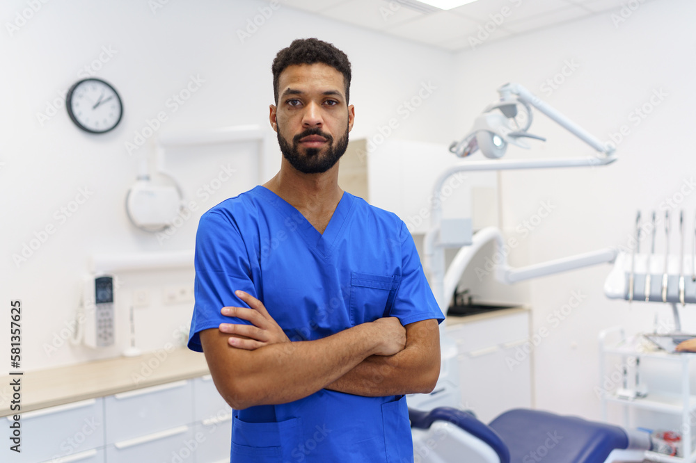 Fototapeta premium Portrait of young multiracial dentist at private dental clinic.