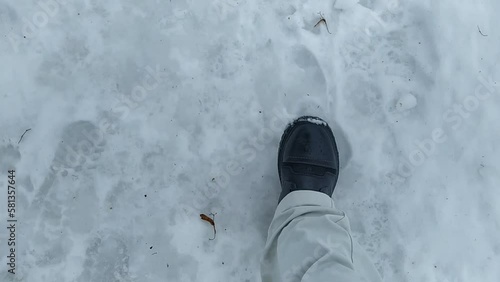 Young man walks through snowdrifts in winter. POV video.