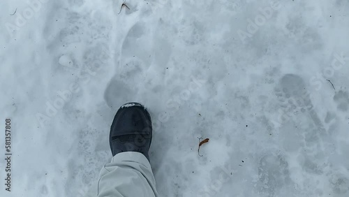 Young man walks through snowdrifts in winter. POV video.