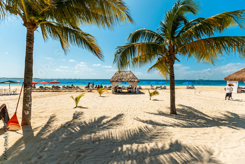 Fototapeta Naklejka Na Ścianę i Meble -  Tropical paradise beach with white sand and coco palms travel tourism wide panorama background. Luxury vacation and holiday, tropical beach resort concept. Beautiful beach design