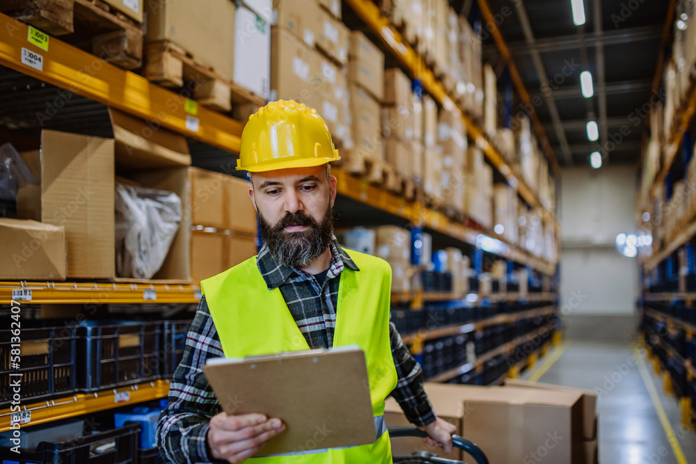 Male warehouse worker dragging a pallet truck. Male warehouse worker dragging a pallet truck.