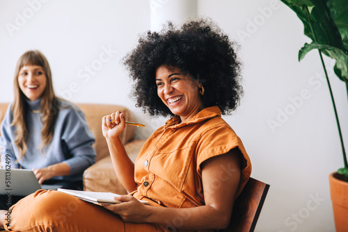 Fotografie Businesswoman smiling happily while sitting in a meeting