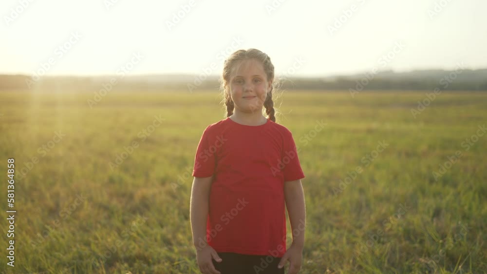 Kid girl walking on sunny day.Child smiles on of nature of park.Young ...