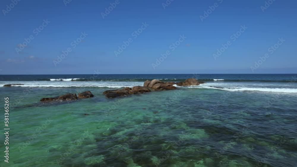Drone shot passing over rocks at Anse forbans beach Mahe Seychelles Drone shot passing over rocks at Anse forbans beach Mahe Seychelles