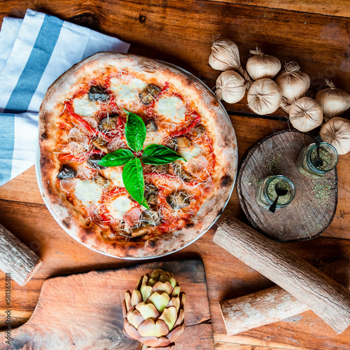 Mediterranean Pizza on wood tabletop with fresh ingredients