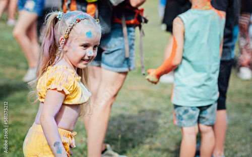 Portrait of happy litttle girl on holi color festival. Cute preschooler girl on holi color festival