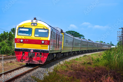 Passenger train by diesel locomotive passed the railway curve.