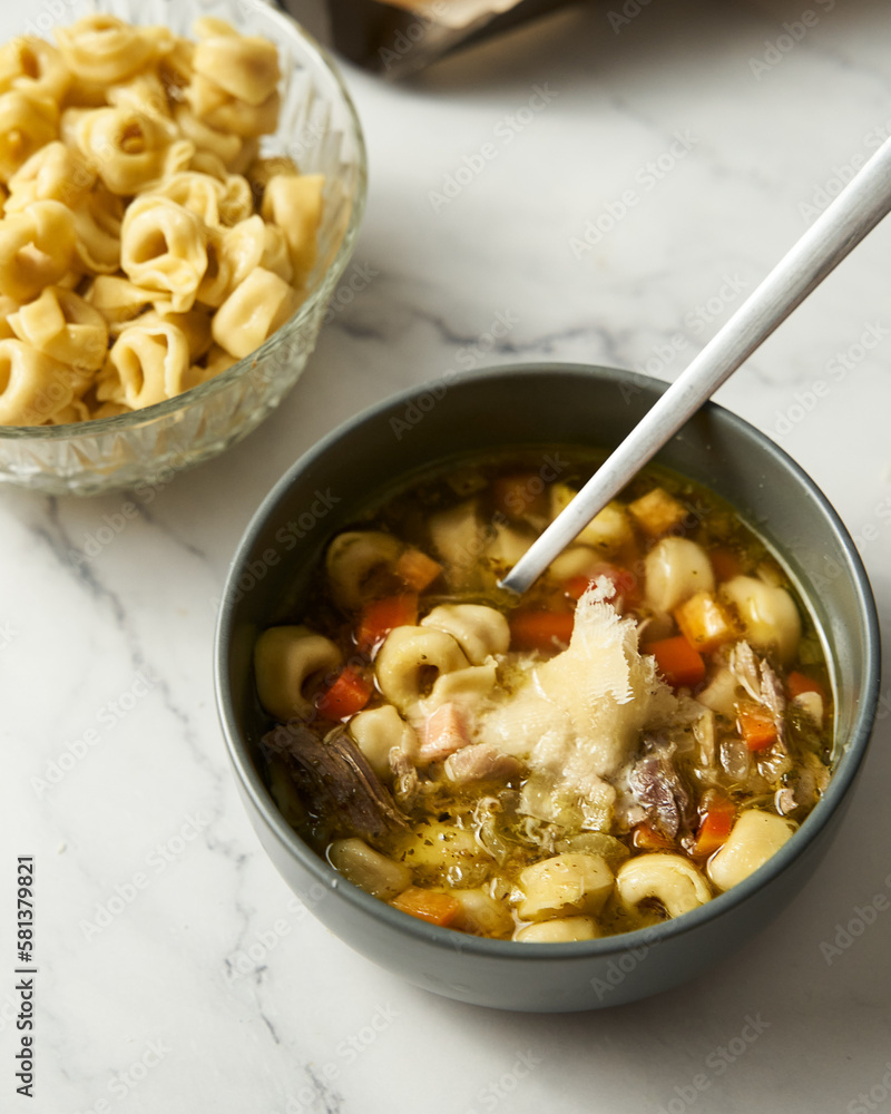 Chicken Tortellini soup. Chicken stock with onion, carrot, celery, bay