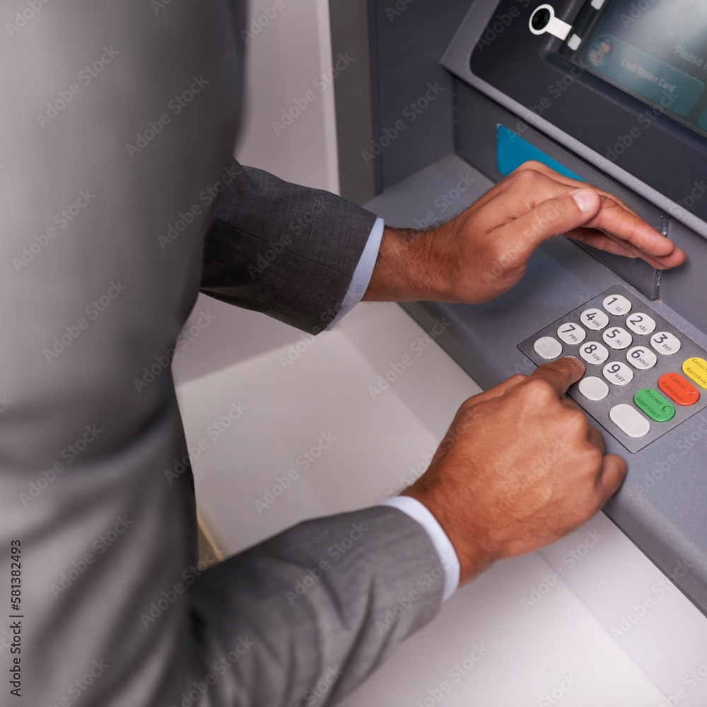 Keep your pin safe. a businessman entering his pin code at an ATM. Keep your pin safe. a businessman entering his pin code at an ATM.