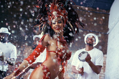 Shes a scintillating samba queen. a beautiful samba dancer performing in a carnival with her band.