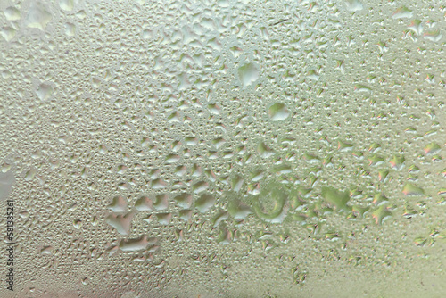 Water drops on a window, textured background, pastel colors, defocused