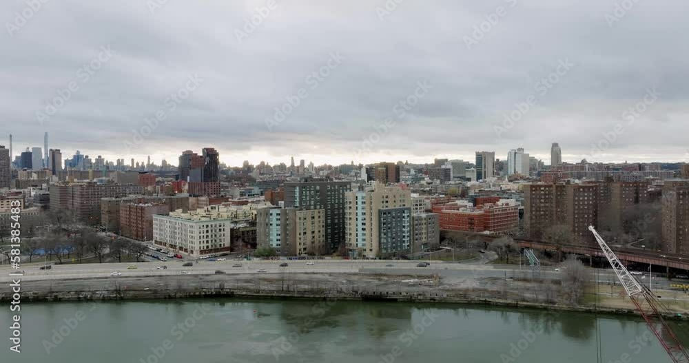 Drone shot over the river and the cityscape of cloudy Harlem, New York, USA Drone shot over the river and the cityscape of cloudy Harlem, New York, USA