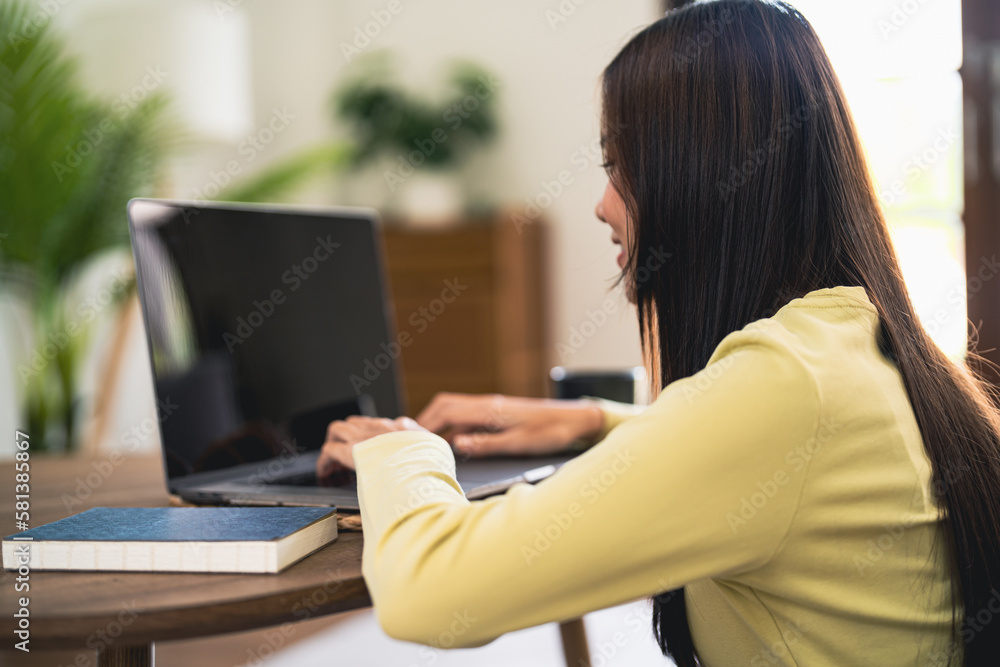 Fototapeta premium Business woman working from home. work online on laptop. Asian businesswoman working on sofa online business with social distancing laptop online meeting