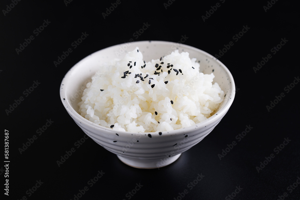 Japanese rice on cup isolated in black background Japanese rice on cup isolated in black background