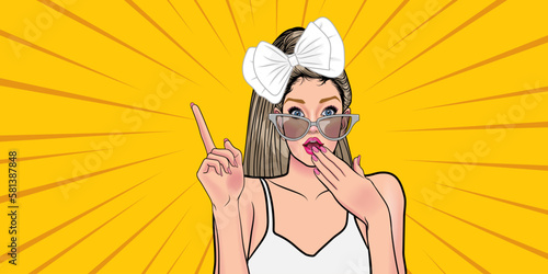 Surprised pop art woman in eyeglasses showing product Beautiful girl pointing at something. Knowledge of your product.