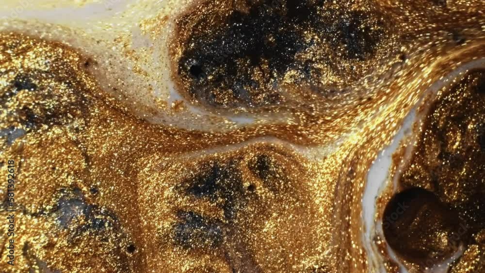 Glitter liquid. Ink mix. Marble texture. Shimmering gold shiny particles black white color paint blend motion abstract background. Glitter liquid. Ink mix. Marble texture. Shimmering gold shiny particles black white color paint blend motion abstract background.