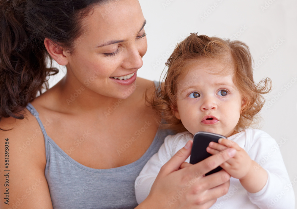 I love mommys cellphone. An adorable baby girl holding her mothers mobile phone. I love mommys cellphone. An adorable baby girl holding her mothers mobile phone.