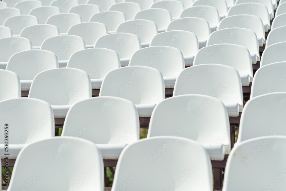 Naklejka premium Seats of tribune on sport stadium. Concept of fans, chairs for audience, cultural environment concept. mpty seats, modern stadium.