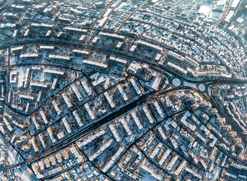 drone view of city streets covered by snow from above