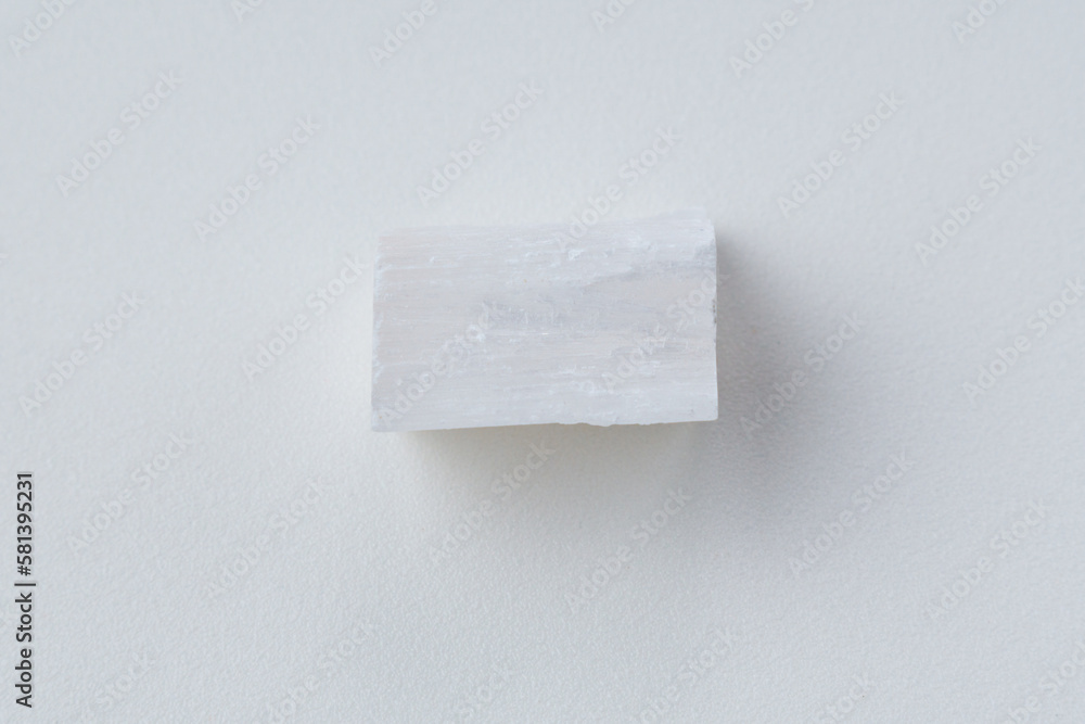 Fototapeta premium White selenite, variety of the mineral gypsum, zen meditation stones, white background