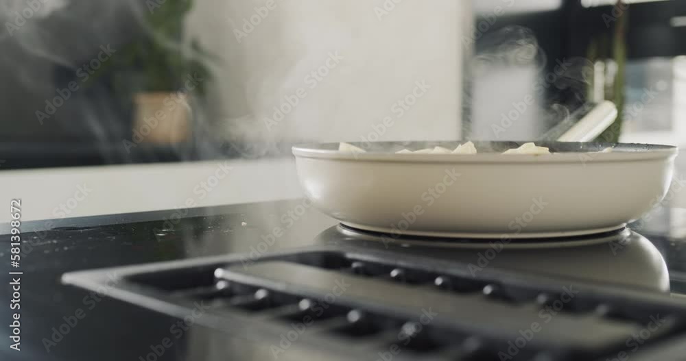 Potatoes are fried on a modern induction cooker. Built-in extractor works. Side view Potatoes are fried on a modern induction cooker. Built-in extractor works. Side view