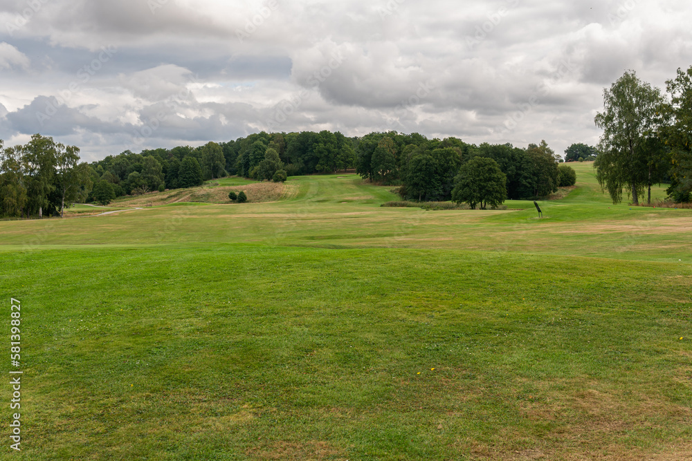 Golf course, golf field on a cloudy summer day. Beautiful nature, green grass. Dynamic sky. Golf course, golf field on a cloudy summer day. Beautiful nature, green grass. Dynamic sky.