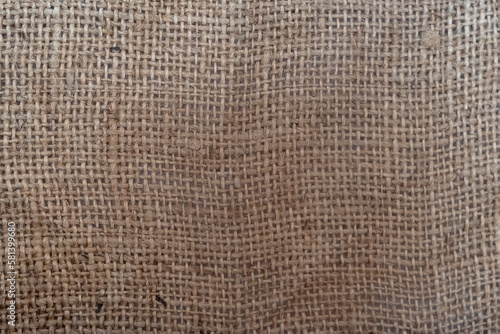 Brown plain burlap fabric sackcloth. Textile background with rough texture.