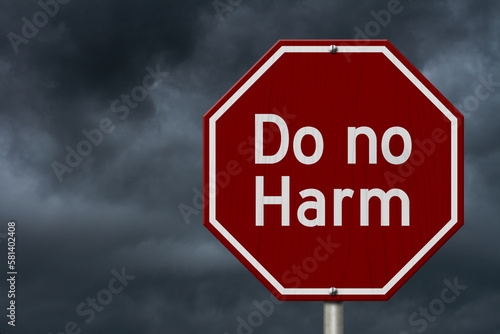 Do no harm message on red street stop sign