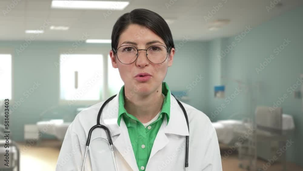 Female Doctor Speaking, Hospital Interior on the Background Female Doctor Speaking, Hospital Interior on the Background