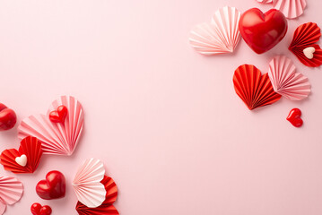 St Valentine's Day concept. Top view photo of pink and red origami paper hearts on isolated pastel pink background with empty space
