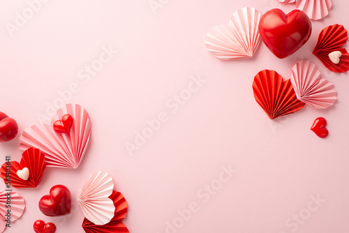 St Valentine's Day concept. Top view photo of pink and red origami paper hearts on isolated pastel pink background with empty space © ActionGP
