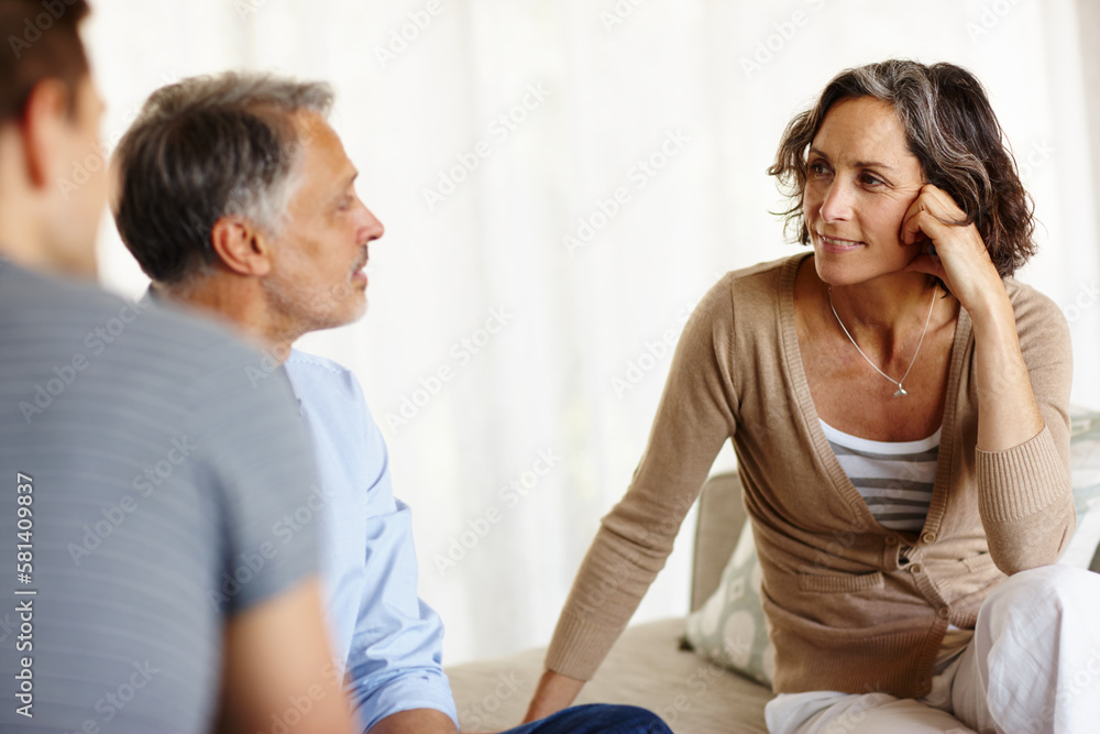We need to talk. a mature couple having a discussion in their home. We need to talk. a mature couple having a discussion in their home.