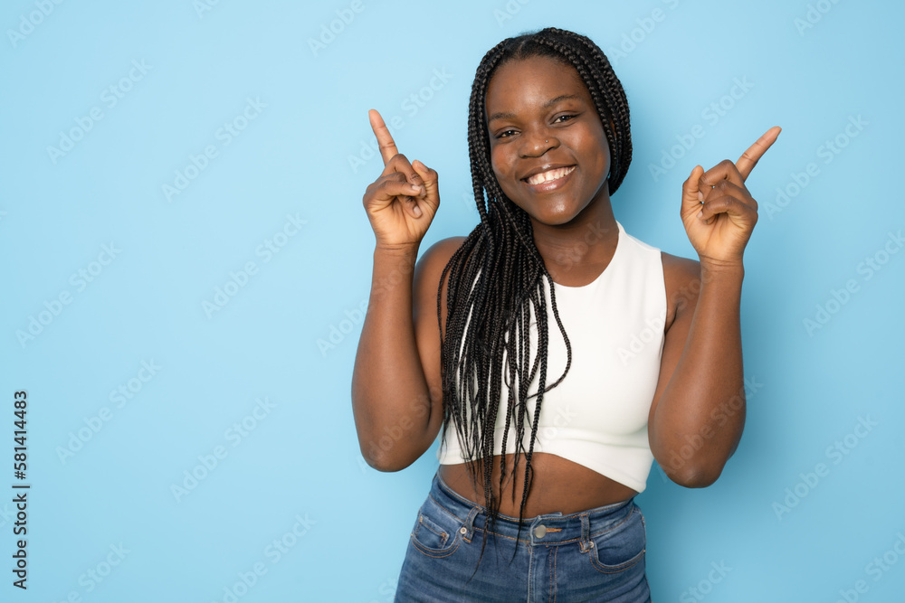 Young african american woman standing casual and cool over blue isolated background pointing fingers up with successful idea. Exited and happy. Number one. Young african american woman standing casual and cool over blue isolated background pointing fingers up with successful idea. Exited and happy. Number one.