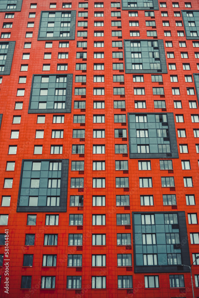 multi-storey house of red color, photo in the afternoon