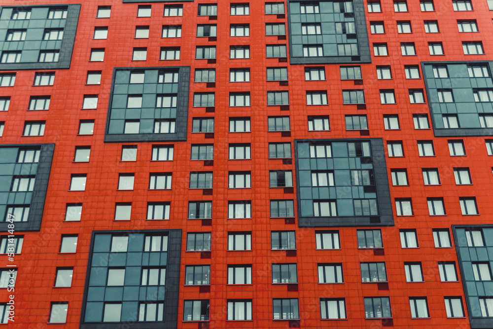 multi-storey house of red color, photo in the afternoon