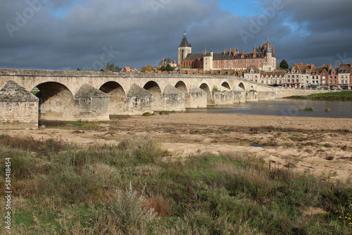 river loire and old stone bridge in gien (france)