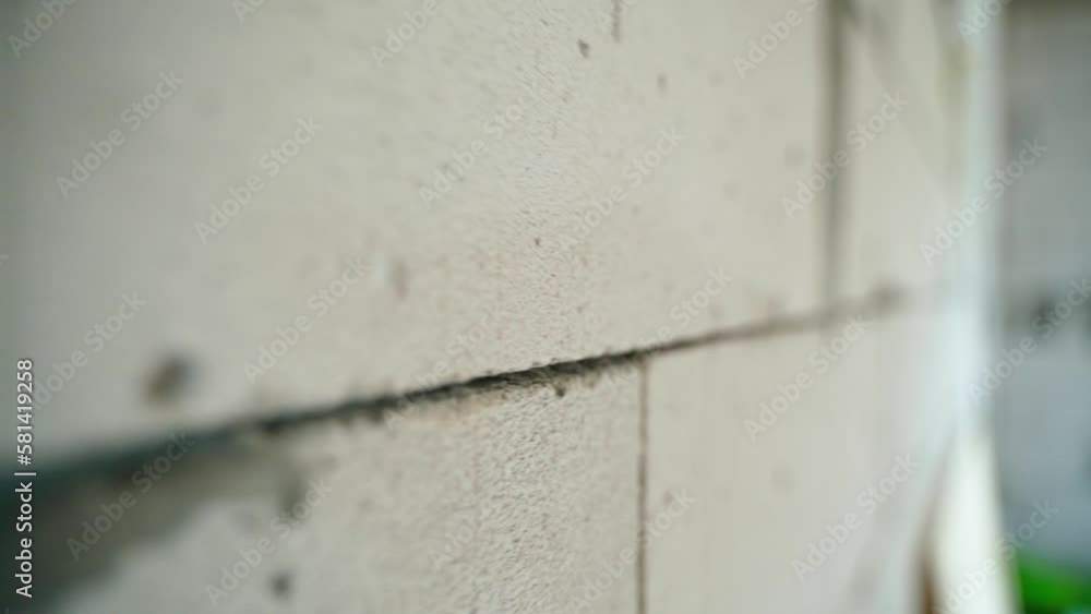 Seam of aerated concrete brick wall close-up. Smooth camera movement along the gas block masonry Seam of aerated concrete brick wall close-up. Smooth camera movement along the gas block masonry