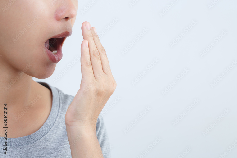 Women have bad breath caused by swollen gums. Women have bad breath caused by swollen gums.