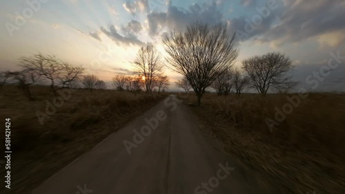 늦겨울 석양이 아름다운 하늘과 갈색으로 물든 들판을 누비다.  photo