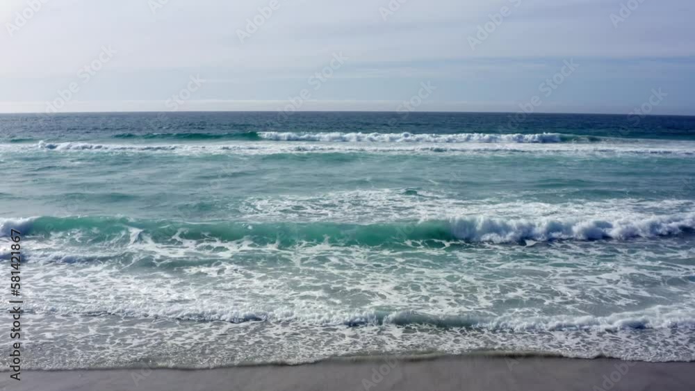 Aerial Shot towards horizon of waves rolling in on Carmel-by-the-Sea Beach Aerial Shot towards horizon of waves rolling in on Carmel-by-the-Sea Beach