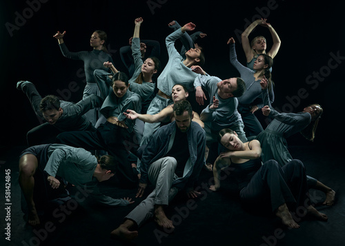 Diversity, chaos and freedom. Group of young people dancing contemp against black studio background. Concept of modern freestyle dance, contemporary art, movements, hobby and creative lifestyle