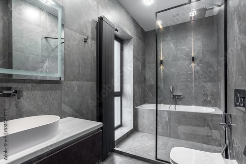 Modern furnished bathroom dark grey interior design with granite tiles