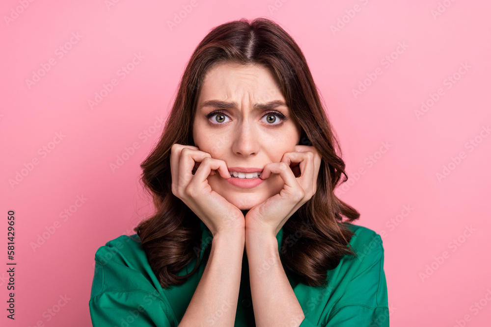 Photo of scared unsure lady dressed green blouse biting hands arms isolated pink color background - obrazy, fototapety, plakaty 